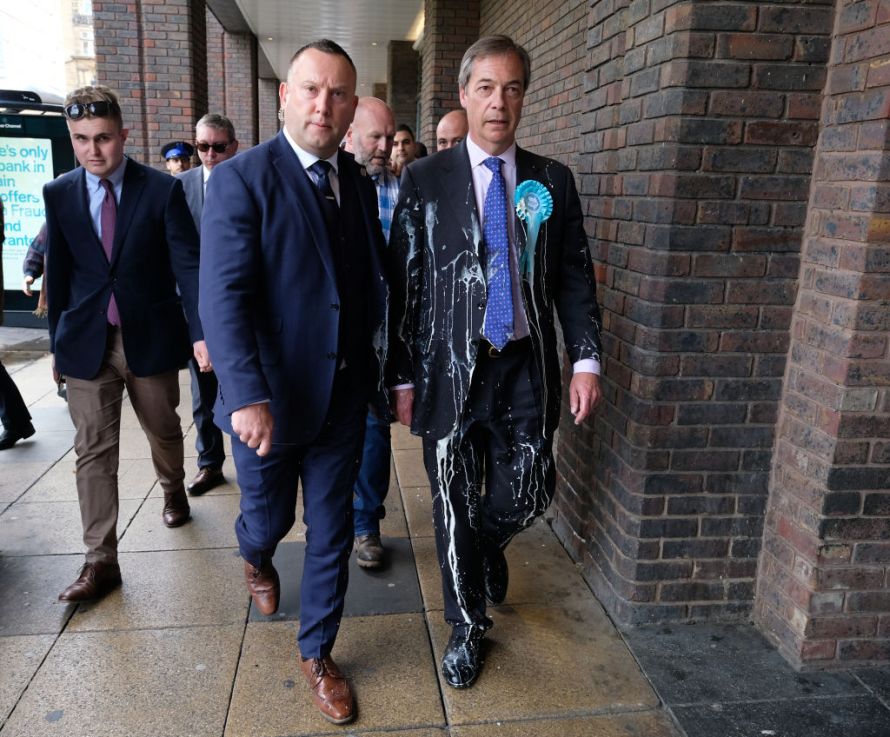 NEWCASTLE-UPON-TYNE, ENGLAND - MAY 20: Brexit Party leader Nigel Farage (R) has what is thought to have been a milkshake thrown over him as he visits Northumberland Street in Newcastle Upon Tyne during a whistle stop UK tour on May 20, 2019 in Newcastle Upon Tyne, England. His visit to Newcastle comes ahead of the 2019 European elections in the United Kingdom which will take place on May 23. The Brexit Party, a pro-Brexit Eurosceptic political party formed in 2019, is reported to be polling in front of Labour and the Conservatives for the European parliament elections. (Photo by Ian Forsyth/Getty Images)