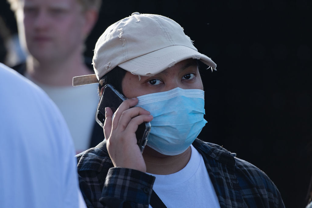 An Asian person wears a face mask to protect against the Covid-19 coronavirus