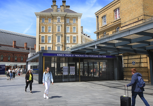 LONDON, ENGLAND - JUNE 21: People pass a closed Kings Cross underground station on June 21, 2022 in London, United Kingdom. The biggest rail strikes in 30 years started on Monday night with trains cancelled across the UK for much of the week. The action is being taken by Network Rail employees plus onboard and station staff working for 13 train operators across England. Thousands of jobs are at risk in maintenance roles and ticket office closures were planned as well as pay freezes during the cost of living crisis, says the RMT union. (Photo by Martin Pope/Getty Images)