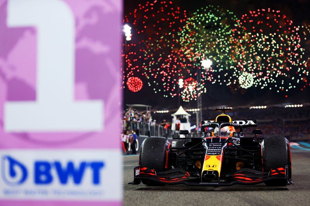 ABU DHABI, UNITED ARAB EMIRATES - DECEMBER 12:   Max Verstappen of the Netherlands and Red Bull Racing drives in to parc ferme after winning the Formula 1 World Championship and F1 Grand Prix of Abu Dhabi at Yas Marina Circuit on December 12, 2021 in Abu Dhabi, United Arab Emirates. (Photo by Dan Istitene - Formula 1/Formula 1 via Getty Images)