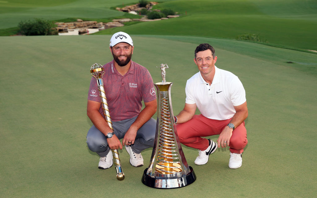 DUBAI, UNITED ARAB EMIRATES - NOVEMBER 20: Jon Rahm of Spain poses with  DP World Tour Championship trophy and Rory McIlroy of Northern Ireland poses with the Harry Vardon trophy during Day Four of the DP World Tour Championship on the Earth Course at Jumeirah Golf Estates on November 20, 2022 in Dubai, United Arab Emirates. (Photo by Andrew Redington/Getty Images)