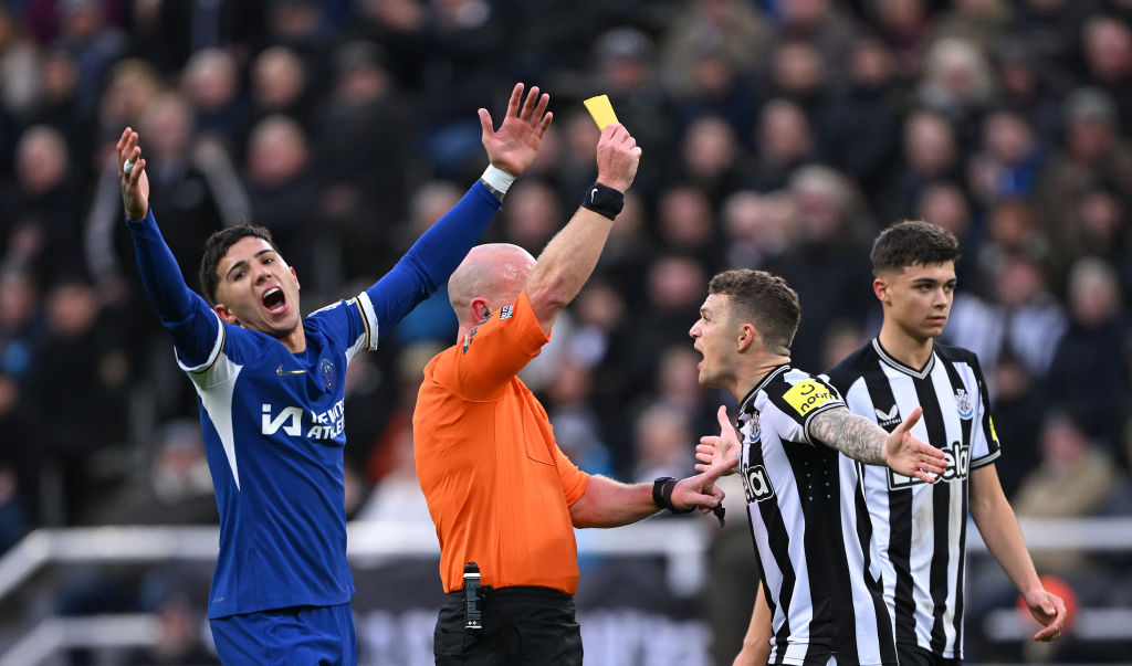 NEWCASTLE UPON TYNE, ENGLAND - NOVEMBER 25: Referee Simon Hooper yellow cards Kieran Trippier of Newcastle as Chelsea player Enzo Fernandez reacts during the Premier League match between Newcastle United and Chelsea FC at St. James Park on November 25, 2023 in Newcastle upon Tyne, England. (Photo by Stu Forster/Getty Images)