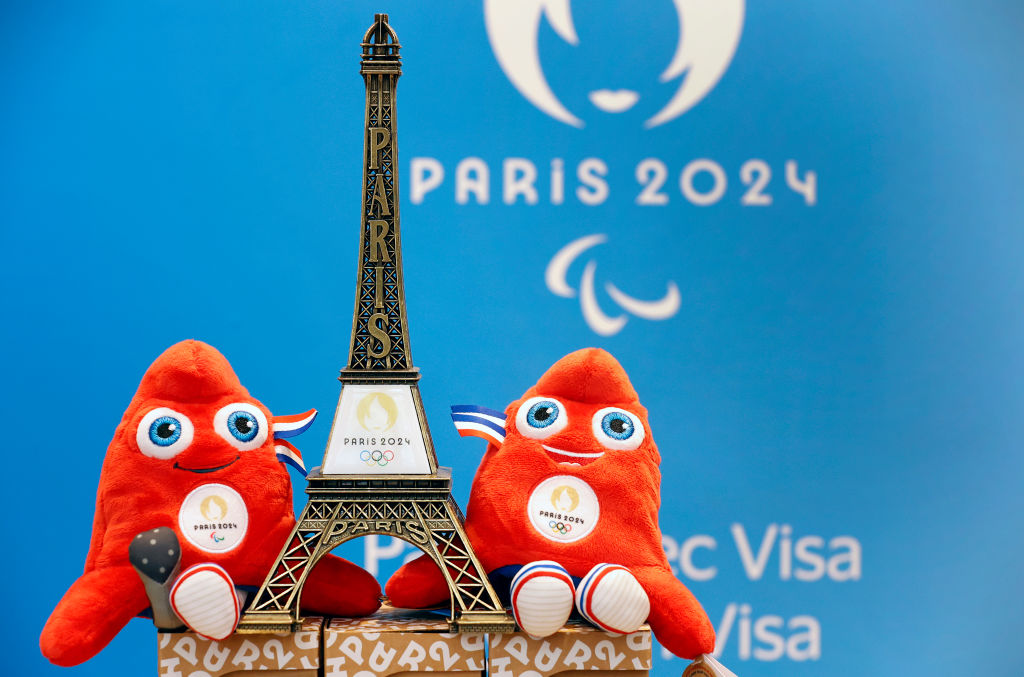 PARIS, FRANCE - NOVEMBER 15: A replica of the Eiffel Tower with the logo of the 2024 Olympic Games surrounded by official mascots for the Paris 2024 Summer Olympic and Paralympic Games is displayed inside the official store entirely dedicated to the 2024 Olympic Games on November 15, 2022 in Paris, France. The public will be able to acquire a large number of official products around the Olympic and Paralympic Games, mugs, t-shirts, pins and other goodies. The mascot represented by a red cap modelled on phrygian caps has been the symbol of freedom since the French Revolution and is still worn by the figure of Marianne, the national personification of France since that time. (Photo by Chesnot/Getty Images)