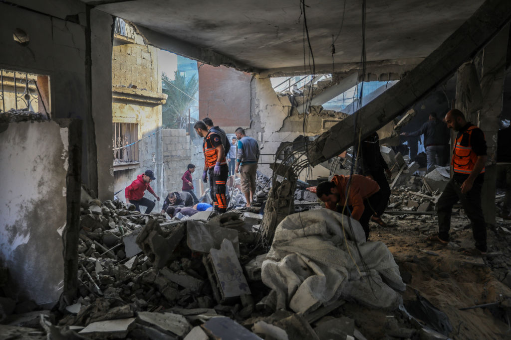 KHAN YUNIS, GAZA - DECEMBER 1: Palestinian citizens inspect the destruction caused by air strikes on their homes on December 01, 2023 in Khan Yunis, Gaza. Israel steps up military operations in Gaza after a sustained truce between Hamas and Israel did not hold further than a week despite diplomatic talks and captives released. (Photo by Ahmad Hasaballah/Getty Images)