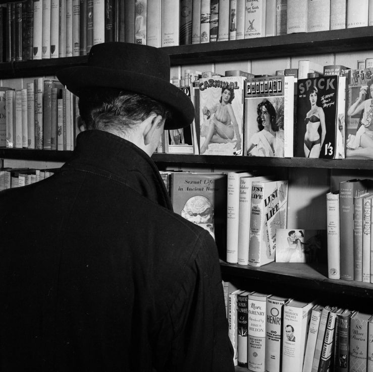 12th June 1956:  A peruser contemplates the pornography section at a Soho sex shop in London.  (Photo by John Firth/BIPs/Getty Images)