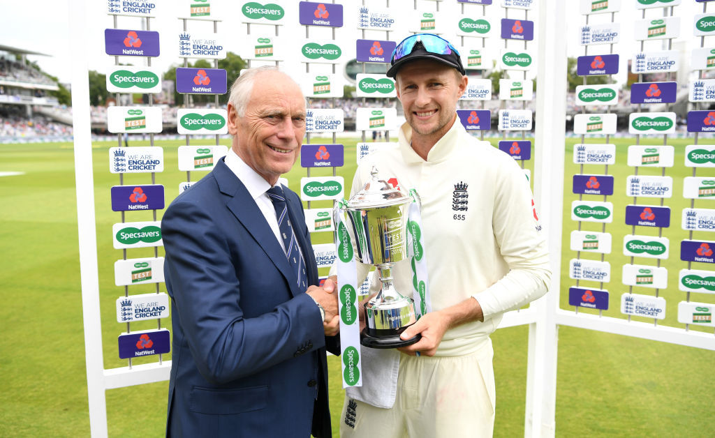 LONDON, ENGLAND - JULY 26: England captain Joe Root is presented with the trophy by ECB Chairman Colin Graves after winning the Specsavers Test Match between England and Ireland at Lord's Cricket Ground on July 26, 2019 in London, England. (Photo by Gareth Copley/Getty Images)