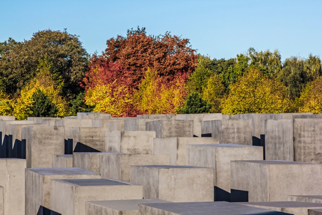 The Memorial to the Murdered Jews of Europe, also known as the Holocaust Memorial (German: Holocaust-Mahnmal), is a memorial in Berlin to the Jewish victims of the Holocaust, designed by architect Peter Eisenman and engineer Buro Happold. It consists of a 19, 000 m2 (4.7-acre) site covered with 2, 711 concrete slabs or ""stelae"", arranged in a grid pattern on a sloping field.