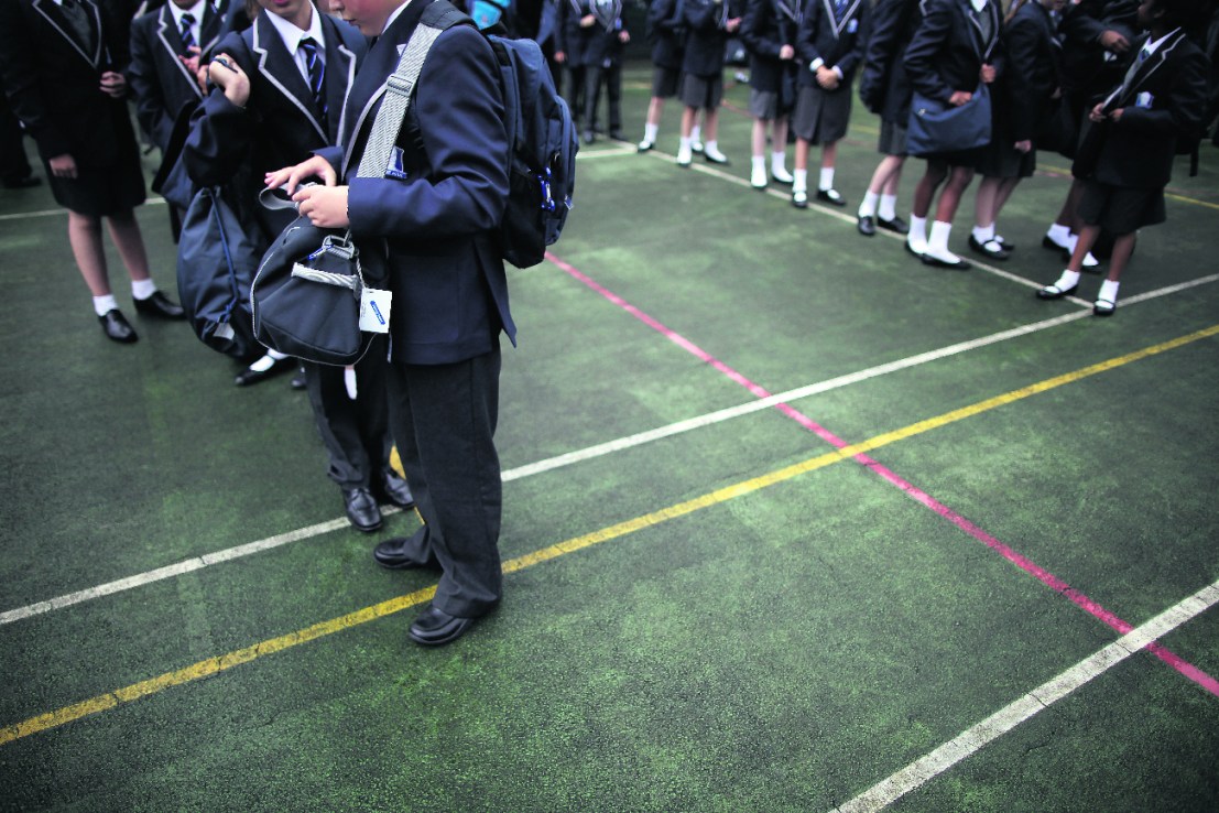 Pupils wait for school buses at a West London school    (Photo by Matthew Lloyd/Getty Images)