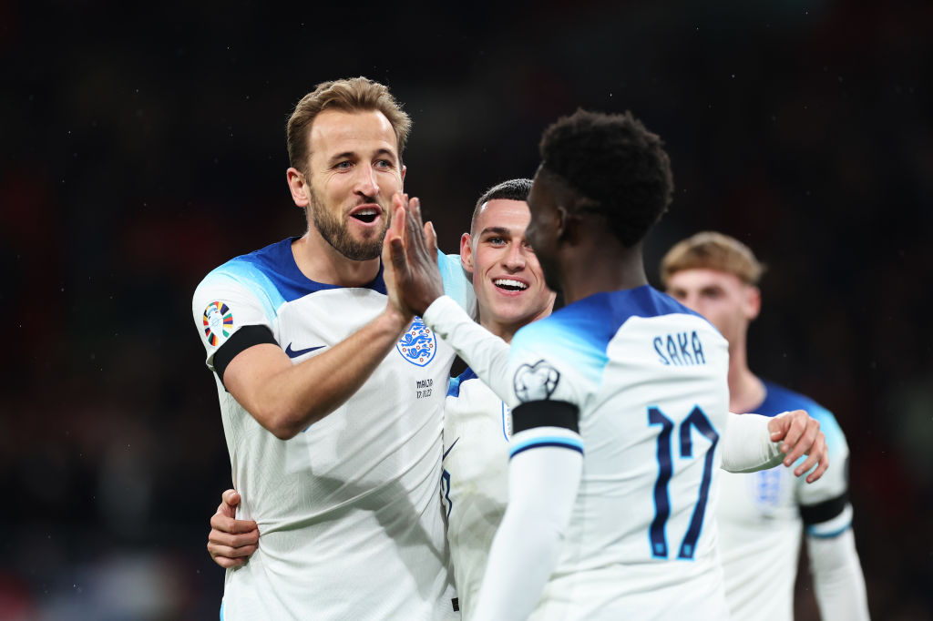 LONDON, ENGLAND - NOVEMBER 17: Harry Kane of England (L) celebrates with teammates Bukayo Saka (R) and Phil Foden after scoring the team's second goal during the UEFA EURO 2024 European qualifier match between England and Malta at Wembley Stadium on November 17, 2023 in London, England. (Photo by Catherine Ivill/Getty Images)