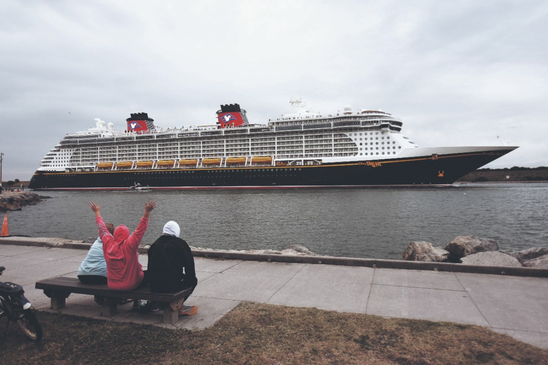 PORT CANAVERAL, FLORIDA, UNITED STATES - 2022/01/28: A person held his hands up as the Disney Dream cruise ship departs from Port Canaveral. (Photo by Paul Hennessy/SOPA Images/LightRocket via Getty Images)