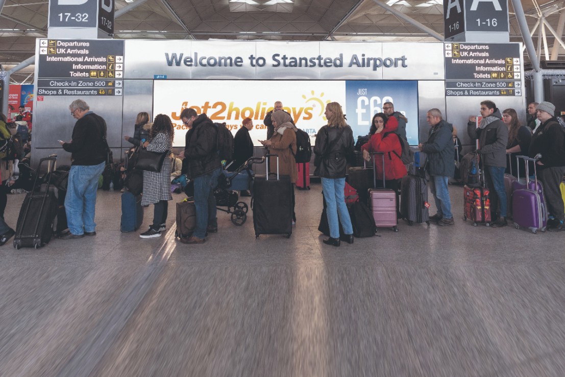 Passengers queue at the check-in area at London Stansted Airport. 
Photographer: Chris Ratcliffe/Bloomberg via Getty Images