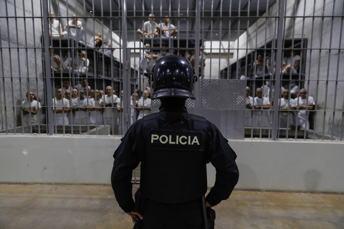 An officer in riot gear stands on patrol inside a cell at CECOT in Tecoluca on February 6, 2024 in San Vicente, El Salvador. On February of 2023 El Salvador inaugurated Latin America's largest prison as part of President Nayib Bukele's plan to fight gangs. Since then, the UN and NGOs have raised concern about the treatment of inmates, minors being held and suspects incarcerated as gang members without sufficient proof. Meanwhile, Bukele claims El Salvador's murder rate has fallen from the world's highest to the lowest in the Western Hemisphere. (Photo by Alex Peña/Getty Images)