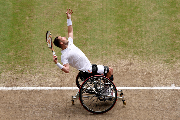 British wheelchair tennis star Alfie Hewett serving at Wimbledon