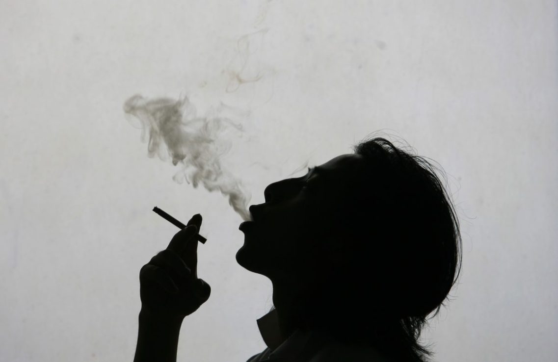 In this photo illustration a man exhales smoke whilst smoking a cigarette on World No Tobacco Day, May 31, 2007 in Nanjing, China.  (Photo by China Photos/Getty Images)