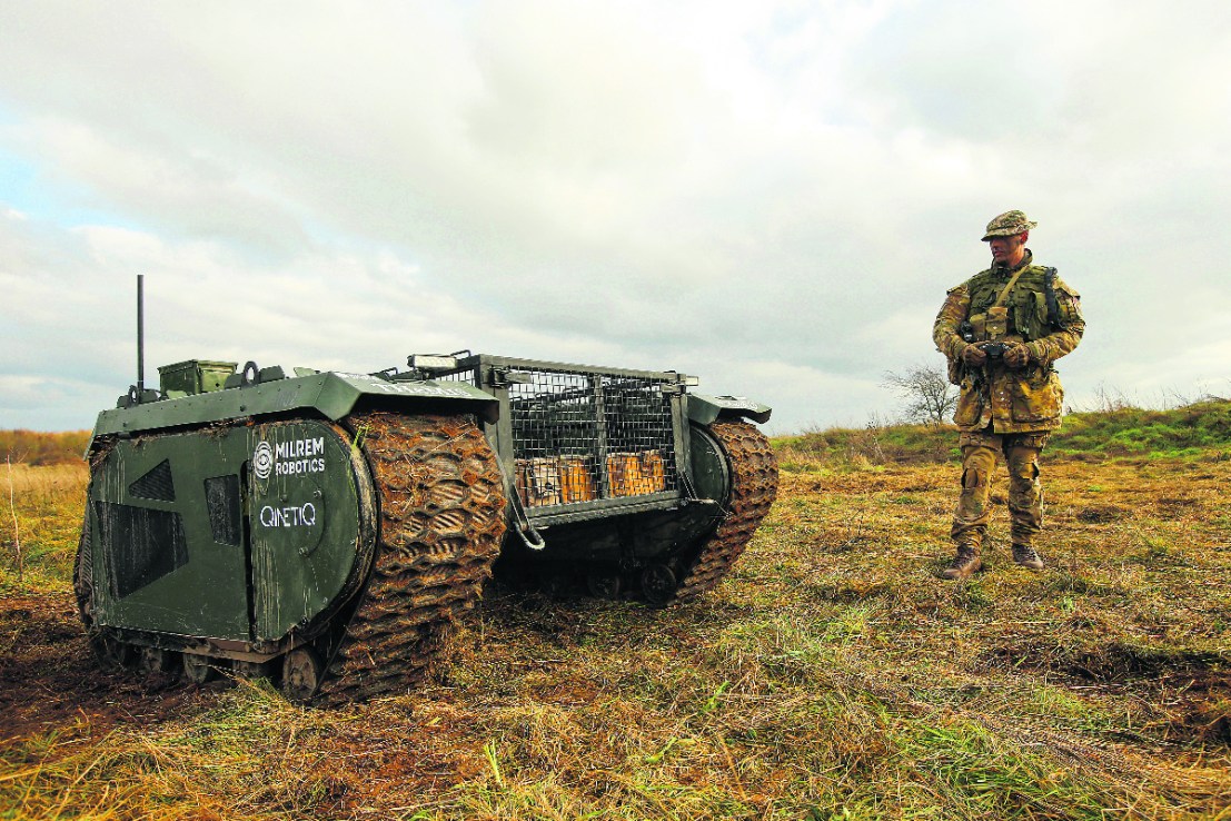 Qinetiq inked a £150m deal with the British Army to deliver "tactical military communications," in the most recent quarter. (Owen Stringer, a rifleman in the British Army, operates a Tracked Hybrid Modular Infantry System, THeMIS, developed by Milrem Robotics and QinetiQ Group Plc,. Photographer: Luke MacGregor/Bloomberg via Getty Images)