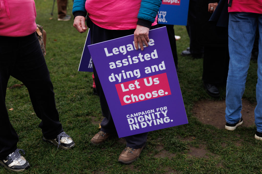 LONDON, ENGLAND - OCTOBER 16: Campaigners in Parliament Square in favour of the proposed bill to legalise assisted dying, on October 16, 2024 in London, England. The 'Terminally Ill Adult (End of Life) Bill' seeks to help terminally ill people with six to 12 months left to live to end their lives legally. As a safeguarding measure, it proposes that a judge and two doctors would need to sign off on a patient's request for an assisted death. A recent poll showed a majority of the public would support assisted deaths for the terminally ill. (Photo by Dan Kitwood/Getty Images)