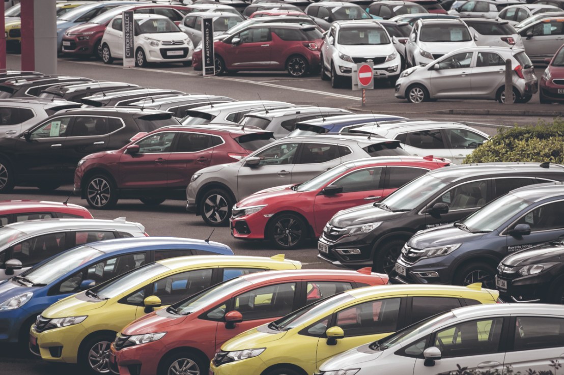 New and nearly new cars are displayed for sale on a forecourt of a car dealership. (Photo by Matt Cardy/Getty Images)