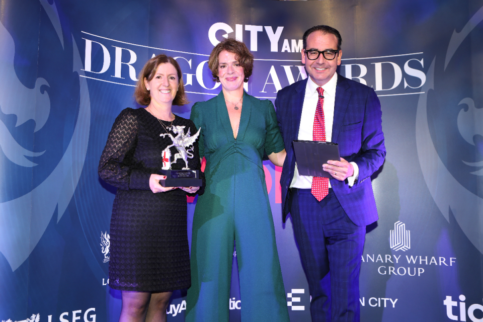 Elvira Lautenschlager, Chief of Staff and CIO, UBS, (left) accepts the award from Streets Consulting's Sarah Durrani and Oli Barrett. City AM Dragon Awards 2024 at Mansion House. (Credit: Gretel Ensignia) 