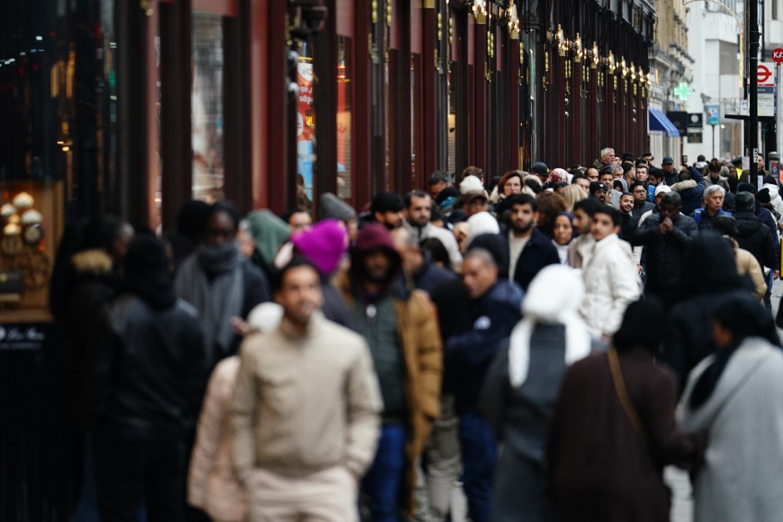 Shoppers wait in line for the start of the Boxing Day sales at the Harrods store in Knightsbridge, London. Photo credit: Jordan Pettitt/PA Wire