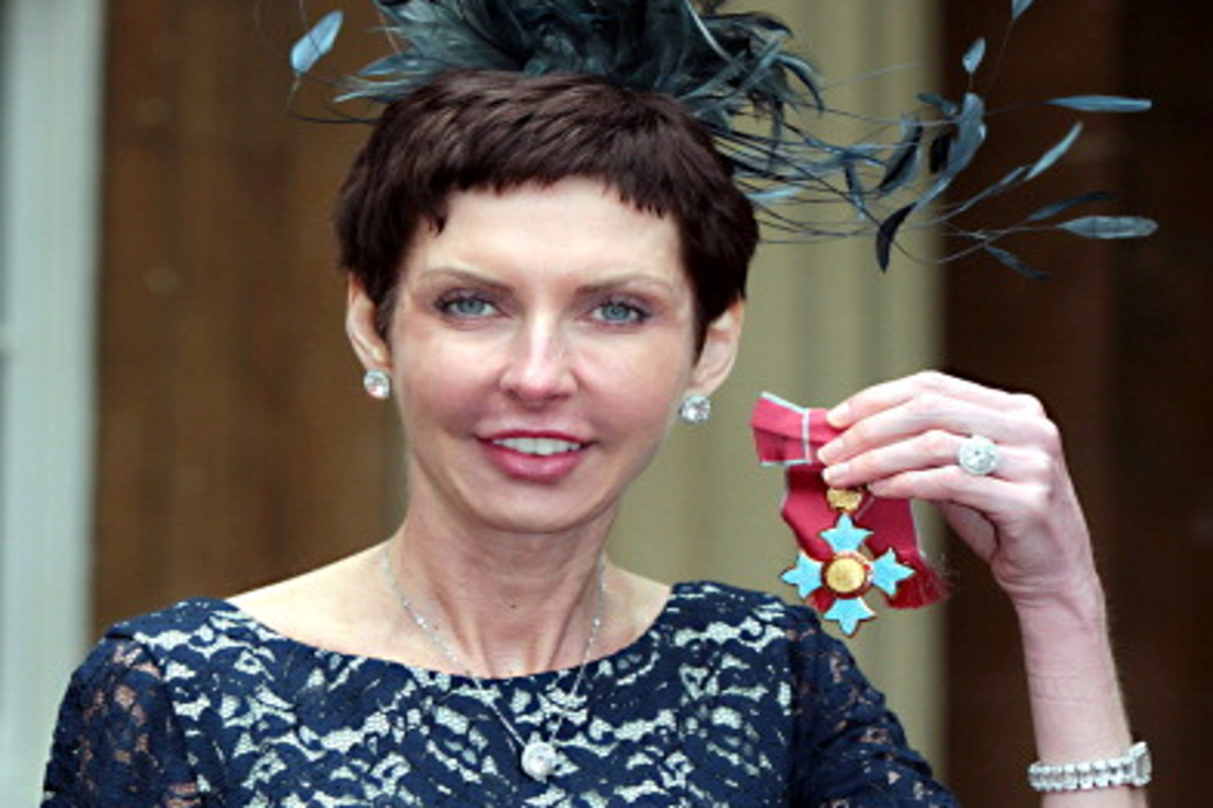 Bet365 chief executive Denise Coates poses with her CBE medal at Buckingham Palace on May 15, 2012. (Photo by Sean Dempsey – WPA Pool/Getty Images)